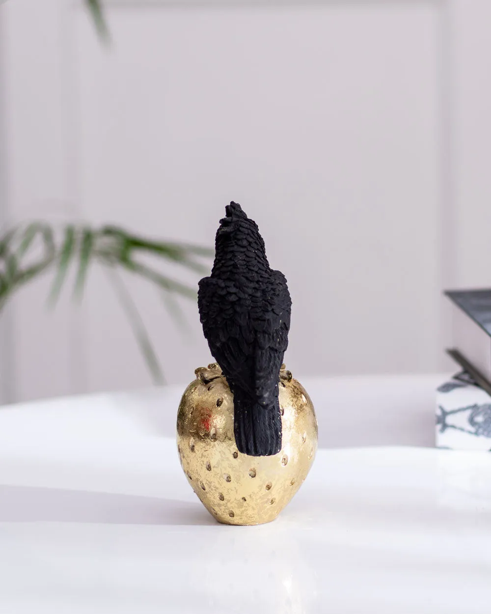 Black Cockatoo Parrot Figurine on a Gold Strawberry