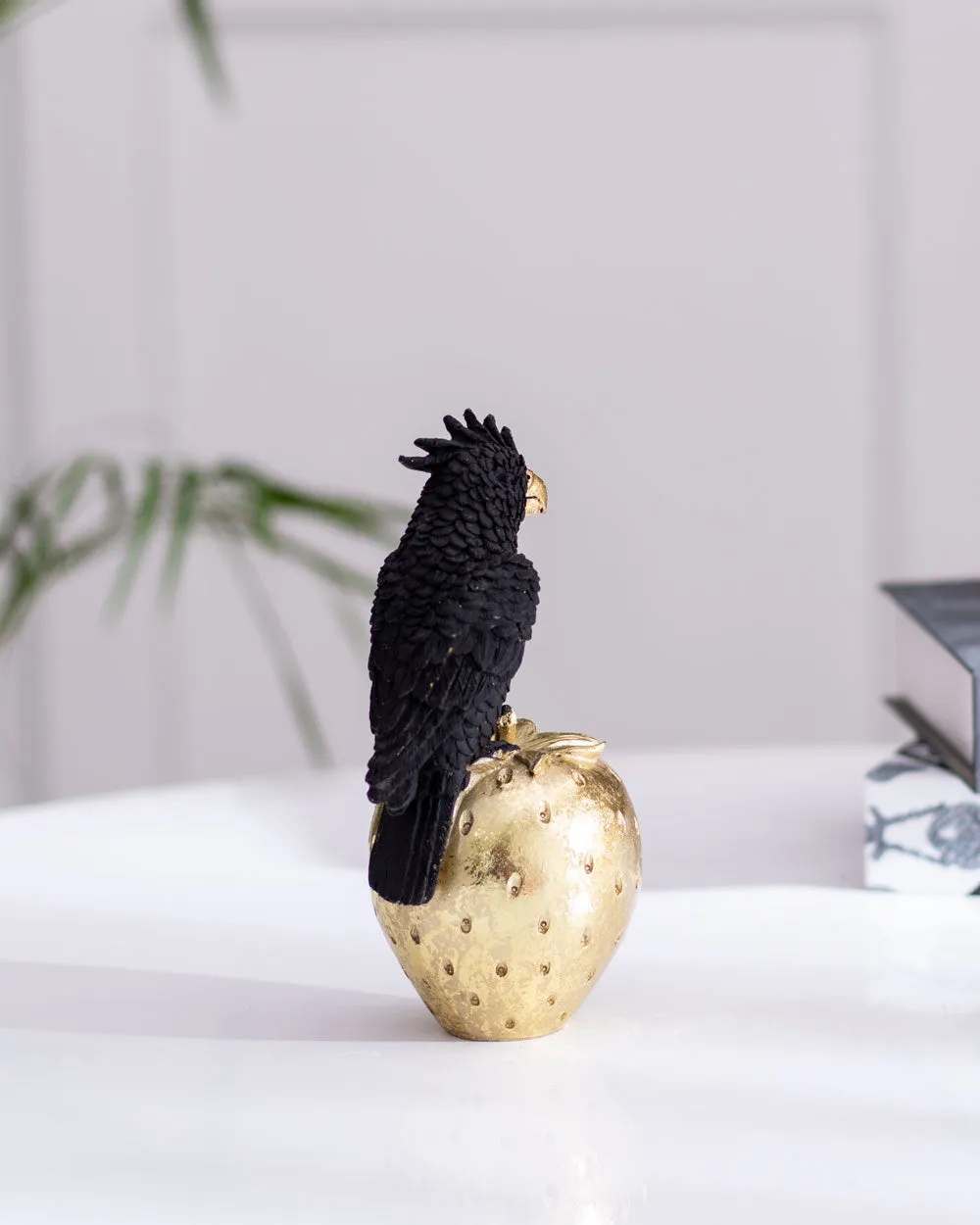 Black Cockatoo Parrot Figurine on a Gold Strawberry